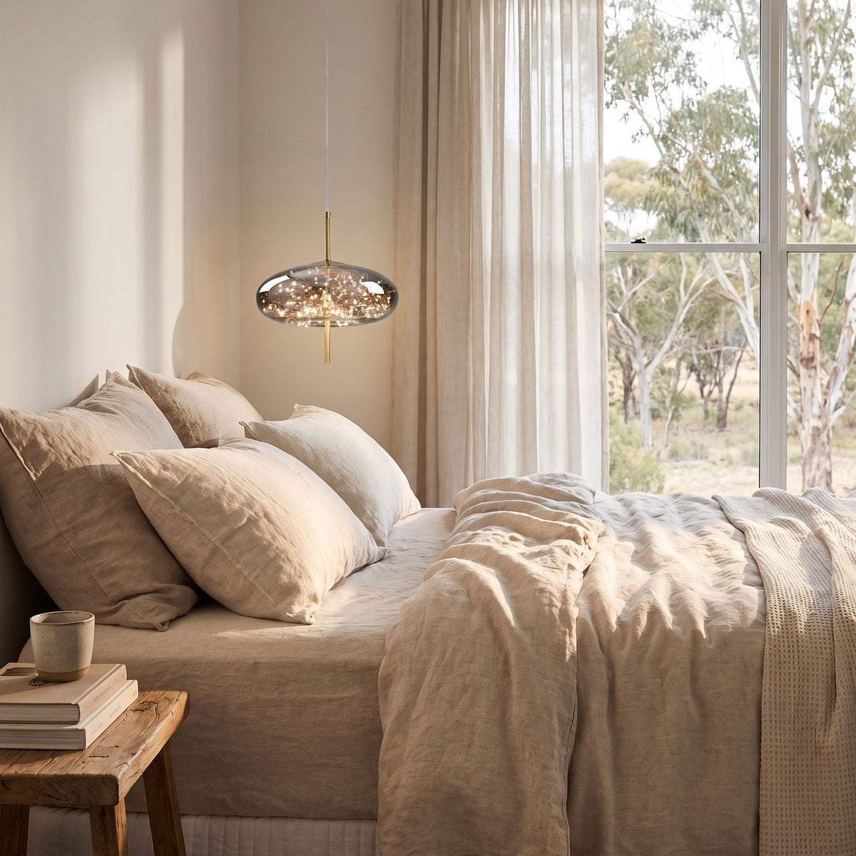 Tinted Glass Capsule and Globe Pendant Light beside a bed as a bedside pendant