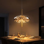 Tinted Glass Capsule and Globe Pendant Light above a dining table at night