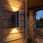 Torch Shape Acrylic Up Down Outdoor Wall Light on a porch wall at dusk