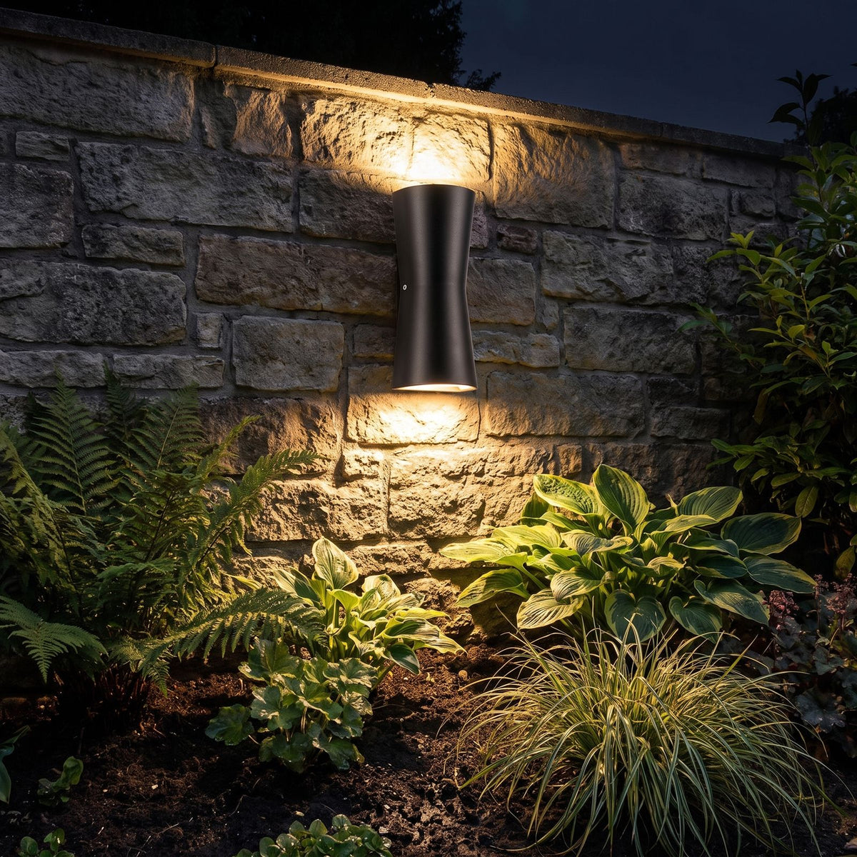 Torch Shape Acrylic Up Down Outdoor Wall Light glowing on a garden wall at night