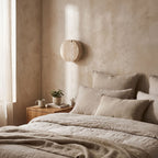 Travertine and Frosted Glass Up Down Wall Light on a bedroom wall beside the bed