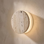 Travertine and Frosted Glass Up Down Wall Light, close view at 45 degrees on a plaster wall