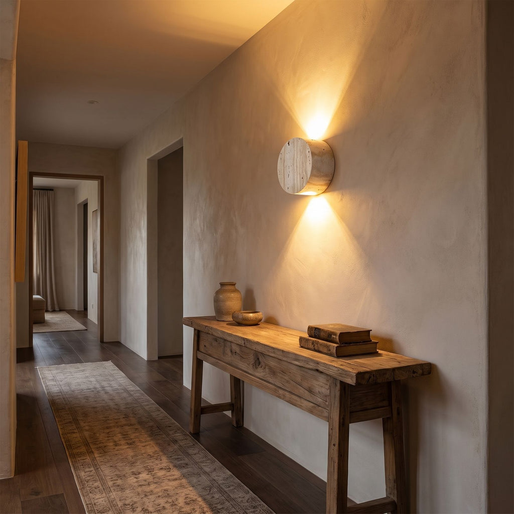 Travertine and Frosted Glass Up Down Wall Light in a hallway above a timber console