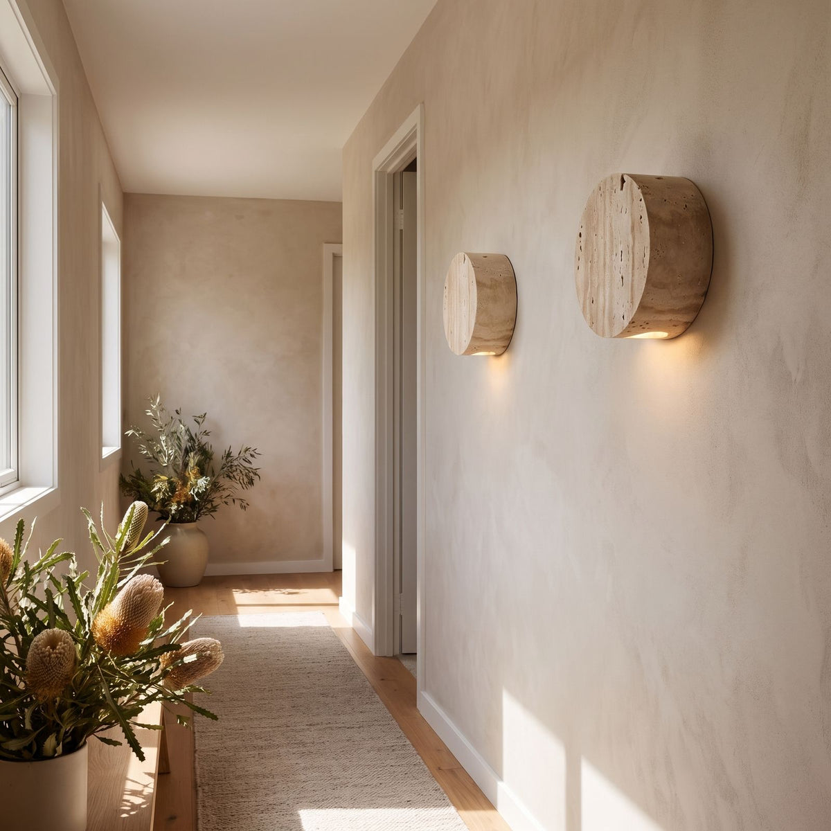 Travertine and Frosted Glass Up Down Wall Light in a pair on a wall of an Australian home