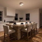 Travertine and Wood Drum Flush Mount Ceiling Light above a kitchen island at night