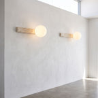 Travertine Bar and White Globe Wall Light in a pair on a wall of an Australian home