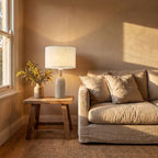 Travertine Base Fabric Shade Table Lamp on a side table beside a sofa