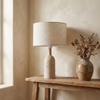 Travertine Base Fabric Shade Table Lamp on a console in an entry hallway