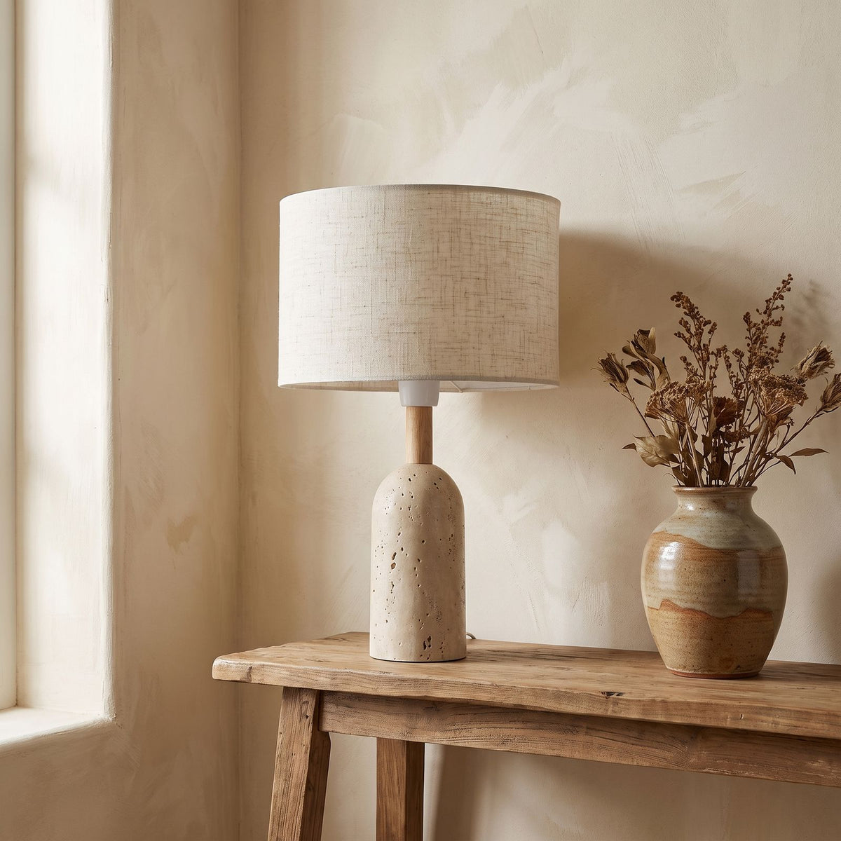 Travertine Base Fabric Shade Table Lamp on a console in an entry hallway
