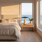 Travertine Column Wide Disc Shade Table Lamp on a bedside table in a bedroom