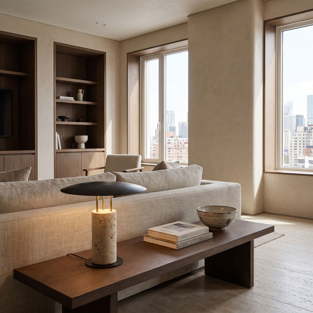 Travertine Column Wide Disc Shade Table Lamp on a side table beside a sofa in a living room
