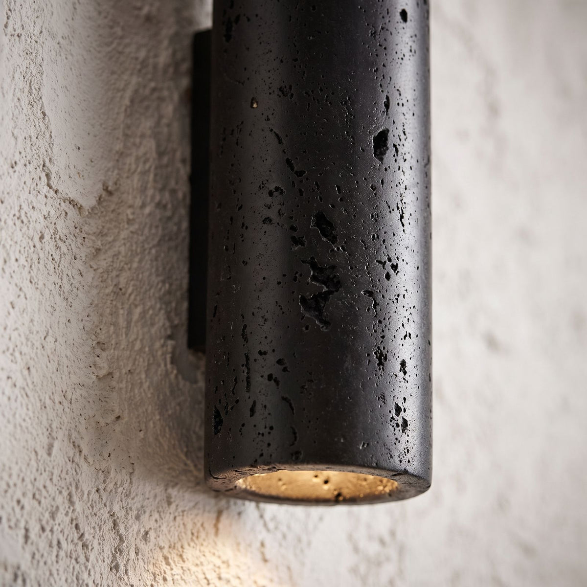 Travertine Cylinder Integrated LED Wall Light, close view at 45 degrees on a plaster wall