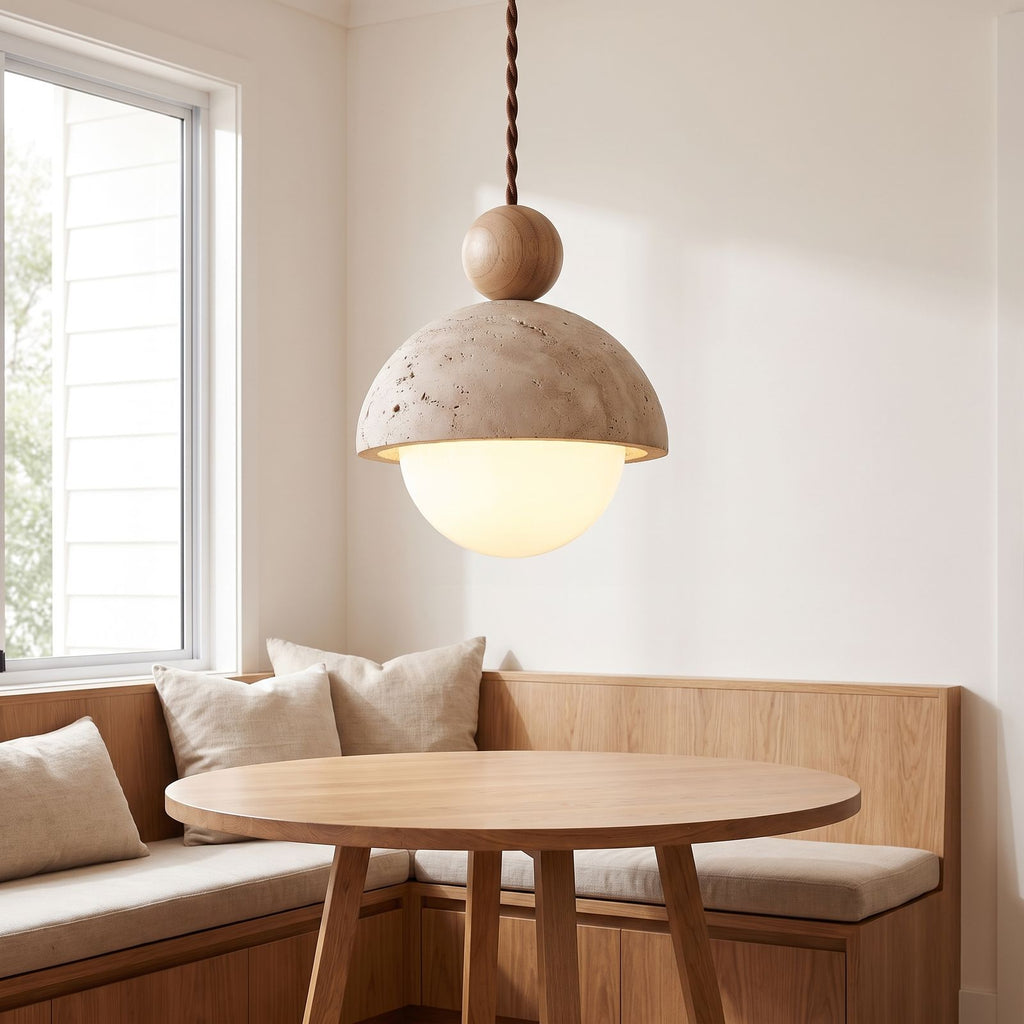 Travertine dome and glass globe pendant light over a breakfast nook table