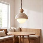 Travertine dome and glass globe pendant light over a breakfast nook table