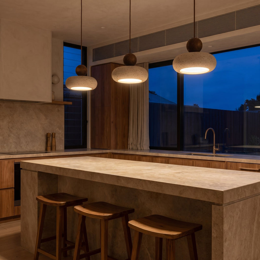 A row of three Travertine Donut and Wood Ball Pendant Lights over a stone kitchen island