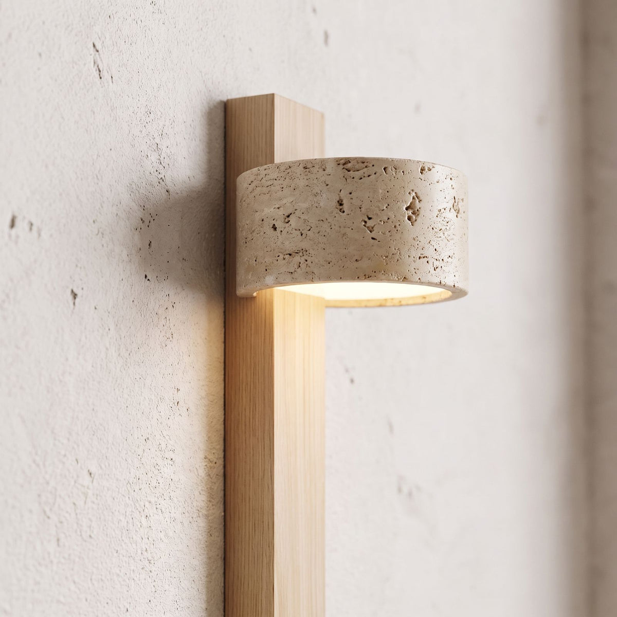 Travertine Drum and Wood Post Swivel Wall Light, close view at 45 degrees on a plaster wall