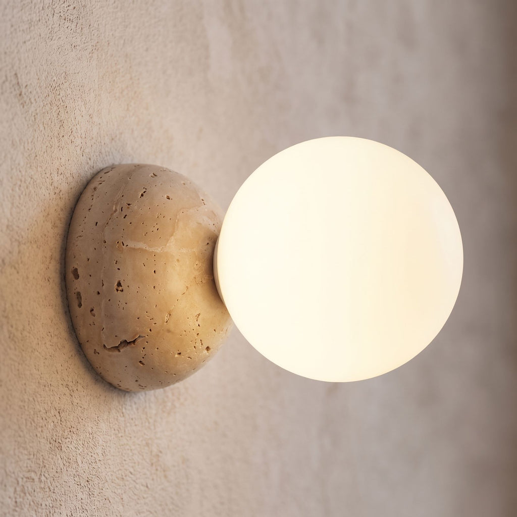 Travertine Half Dome Glass Orb Wall Light, close view at 45 degrees on a plaster wall