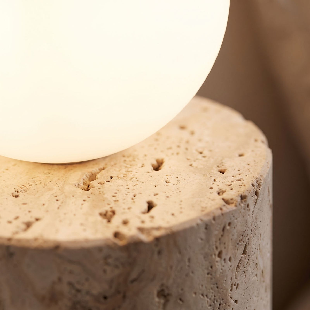 Close-up of the travertine ledge and frosted glass orb