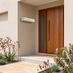 Travertine Look Resin Linear Up Down Outdoor Wall Light beside a timber front door