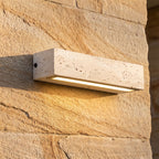 Travertine Look Resin Linear Up Down Outdoor Wall Light, close view at 45 degrees on a stone wall