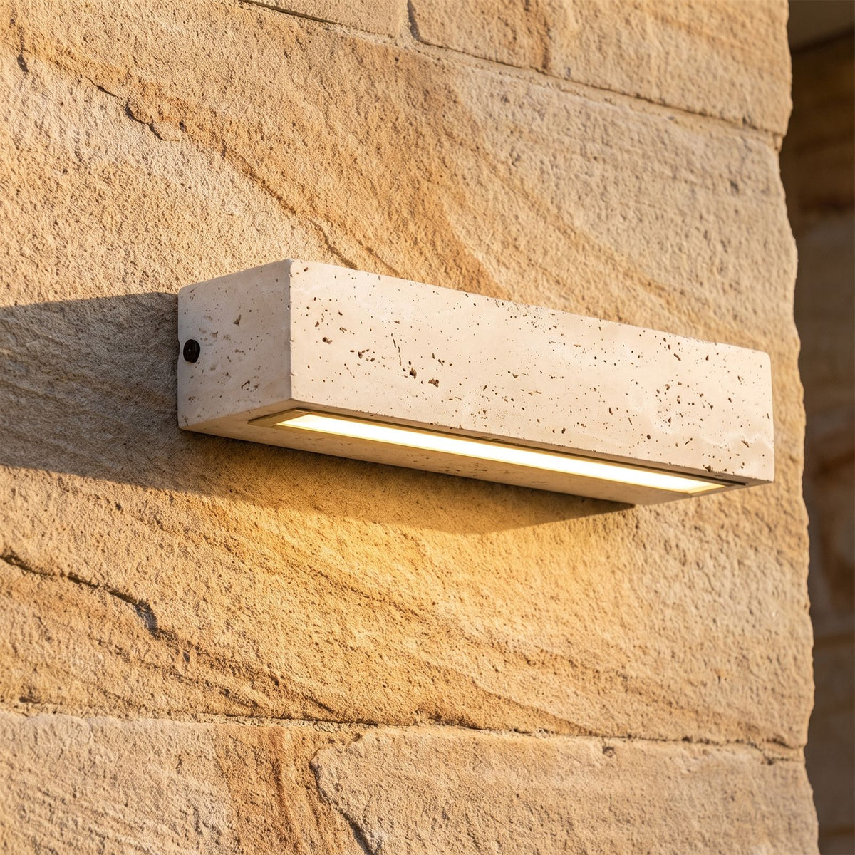 Travertine Look Resin Linear Up Down Outdoor Wall Light, close view at 45 degrees on a stone wall