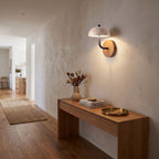 Travertine Mushroom Dome Bedside Wall Light in a hallway above a timber console