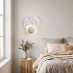 Travertine Pattern Marble Disc and Orb Wall Light on a bedroom wall beside the bed