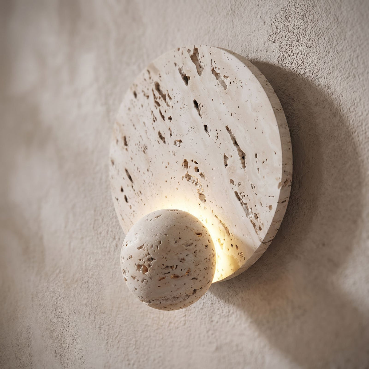 Travertine Pattern Marble Disc and Orb Wall Light, close view at 45 degrees on a plaster wall