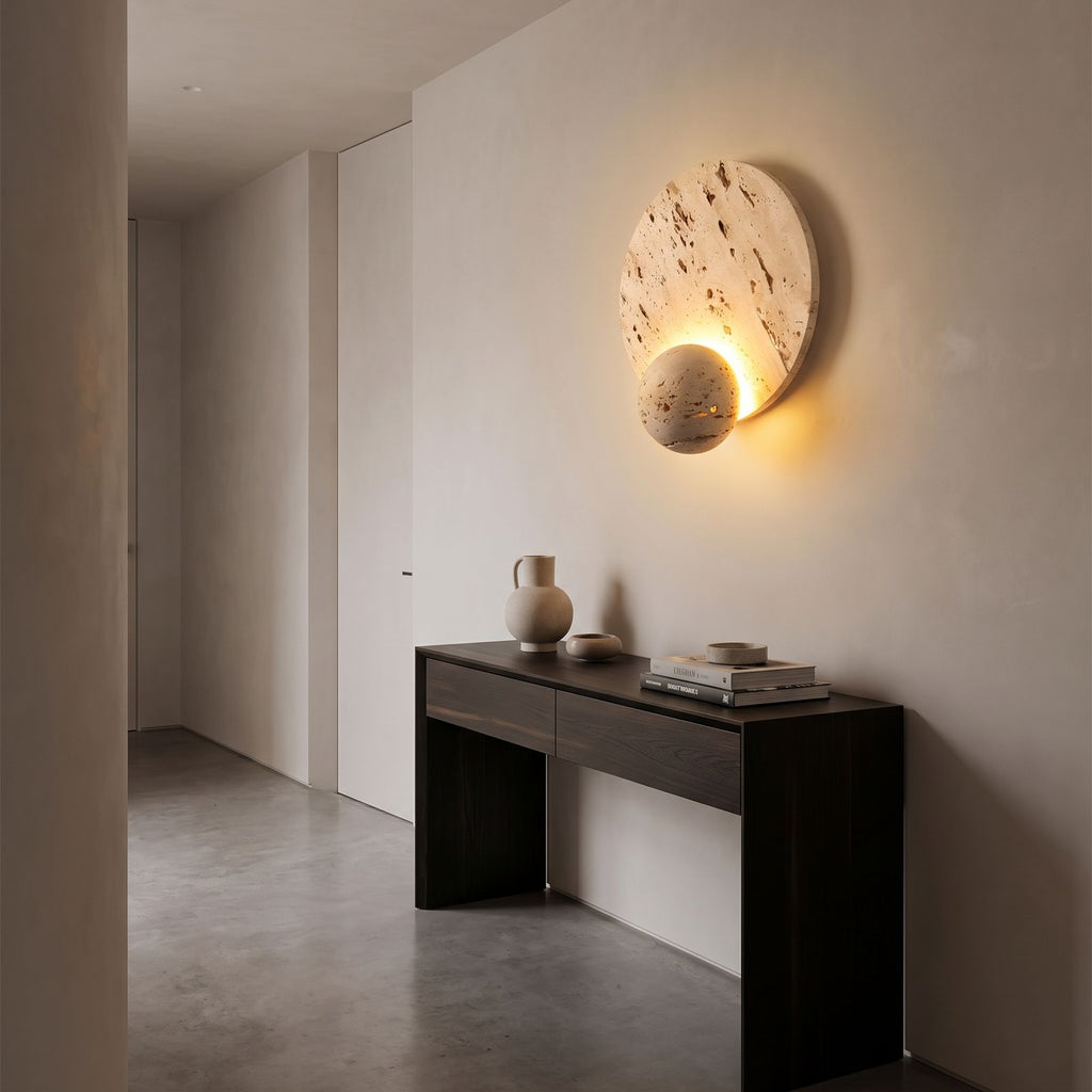 Travertine Pattern Marble Disc and Orb Wall Light in a hallway above a timber console