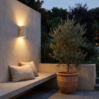 Travertine Stone Outdoor Up Down Wall Light above a courtyard bench