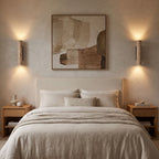 A pair of Travertine Tube Up Down Wall Lights either side of a bedhead