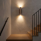 Travertine Tube Up Down Wall Light beside a staircase