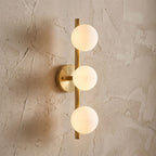 Triple Frosted Glass Orb Vertical Wall Light, close view at 45 degrees on a plaster wall