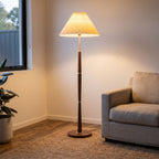 Turned Wood Pleated Shade Floor Lamp beside an armchair in a living room corner