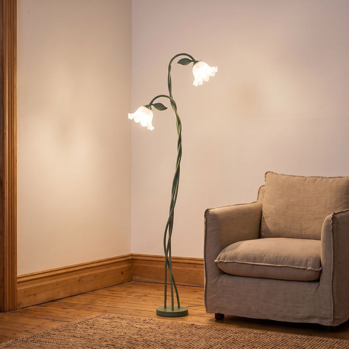 Twisted Green Stem Flower Shade Floor Lamp beside an armchair in a living room corner