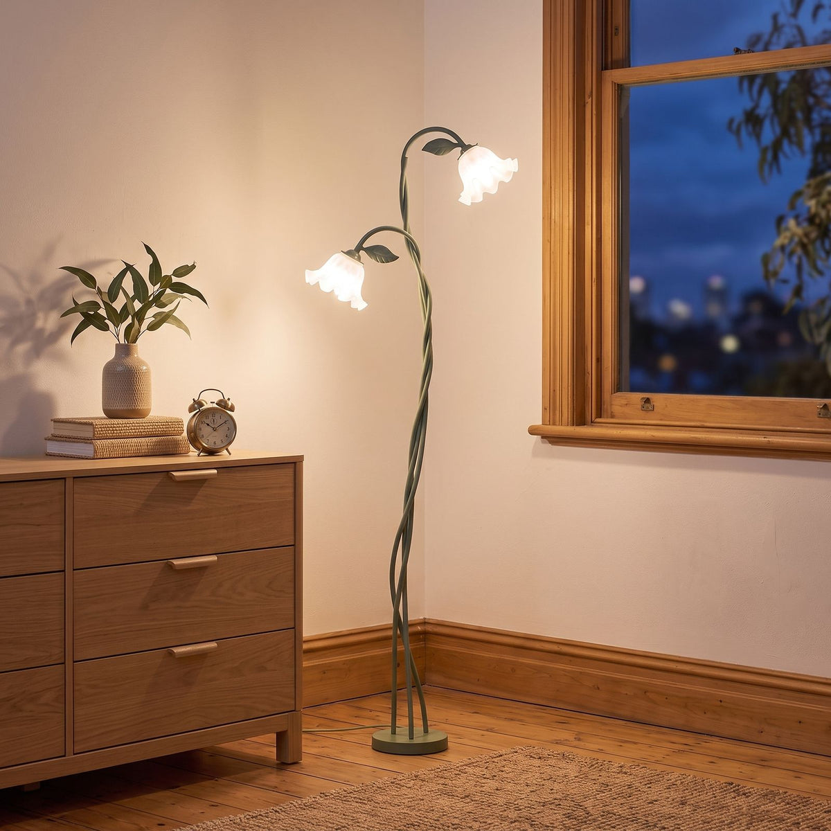 Green stem flower shade floor lamp in a bedroom corner beside a dresser