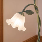 Close-up of a frosted flower shade, leaf and green stem