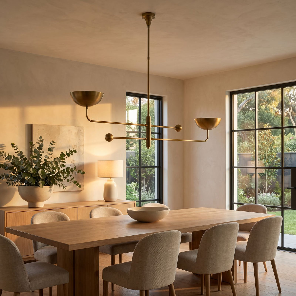 Two Arm Bowl Shade and Ball Chandelier above a dining table at golden hour