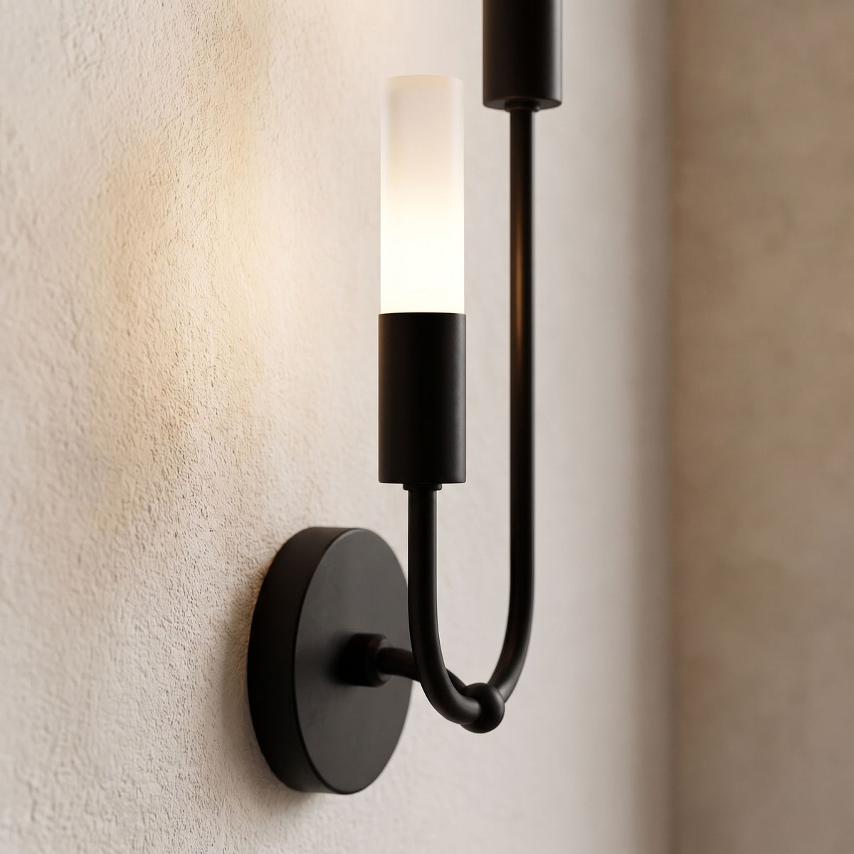Two-Arm Iron and Acrylic Tube Wall Light, close view at 45 degrees on a plaster wall