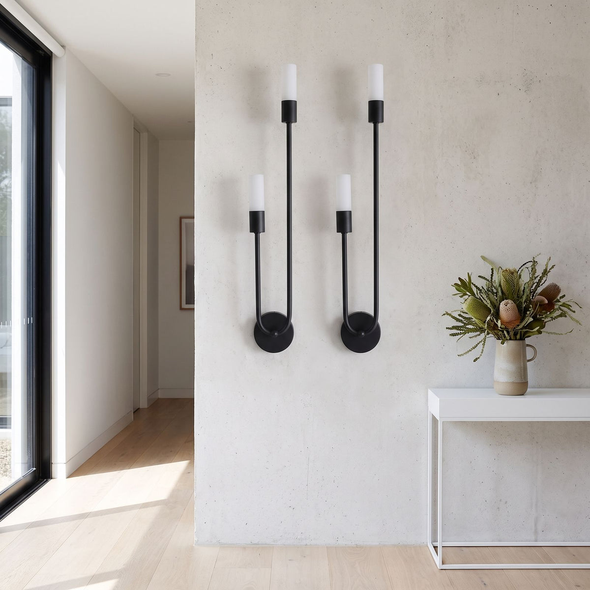 Two-Arm Iron and Acrylic Tube Wall Light in a pair on a wall of an Australian home