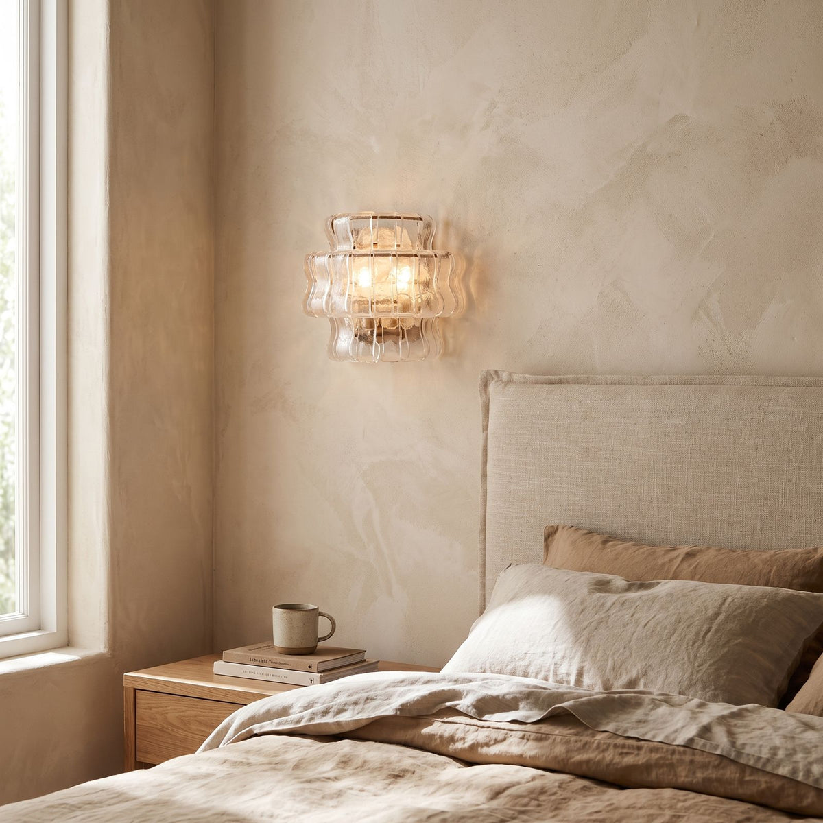 Two Tier Fluted Glass Brass Wall Sconce on a bedroom wall beside the bed