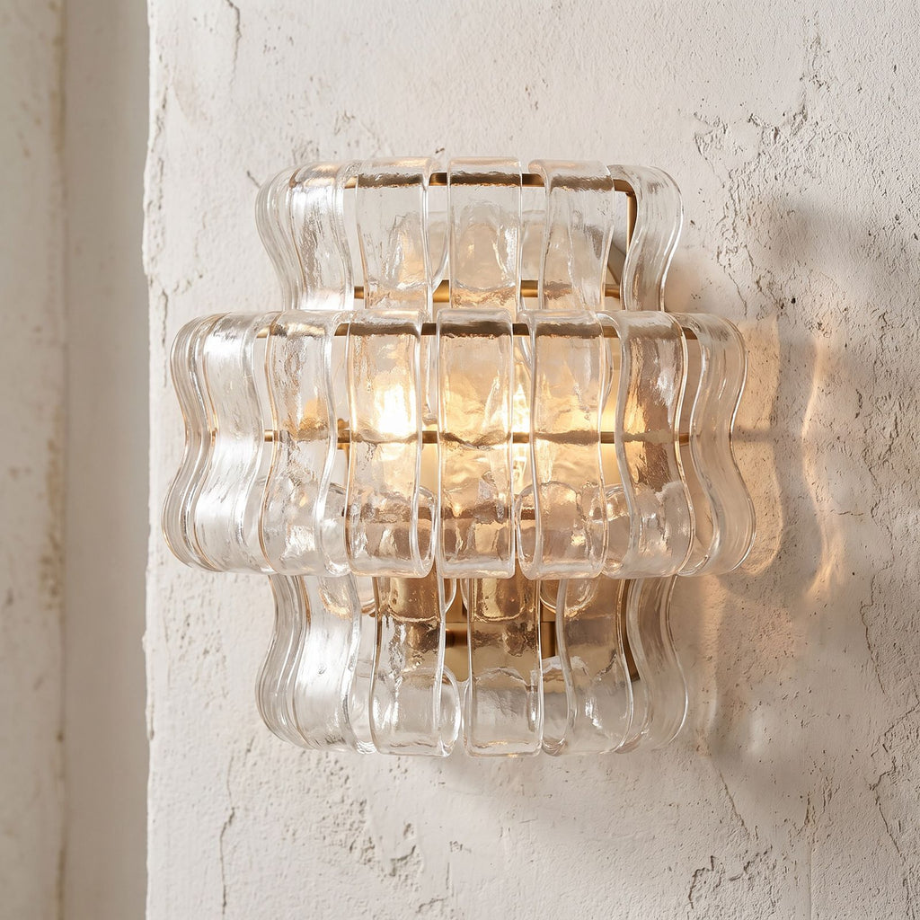 Two Tier Fluted Glass Brass Wall Sconce, close view at 45 degrees on a plaster wall