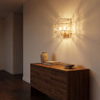 Two Tier Fluted Glass Brass Wall Sconce in a hallway above a timber console