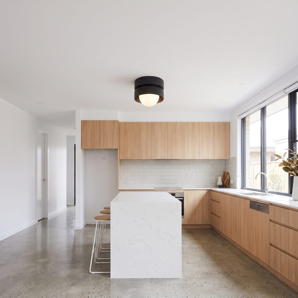 Two-tier resin drum ceiling light in a wide hallway view