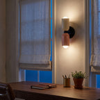 Two Tone Double Head Iron Wall Light above a walnut desk