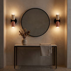 A pair of Two Tone Double Head Iron Wall Lights either side of a round mirror
