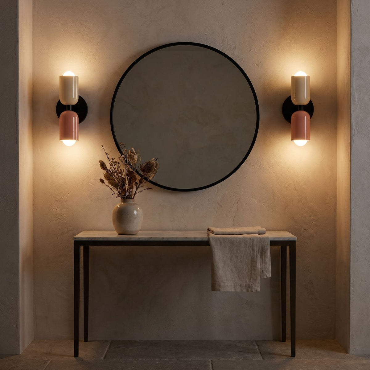 A pair of Two Tone Double Head Iron Wall Lights either side of a round mirror