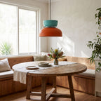Two-Tone Stacked Metal Bowl Pendant Light above a round table in a breakfast nook