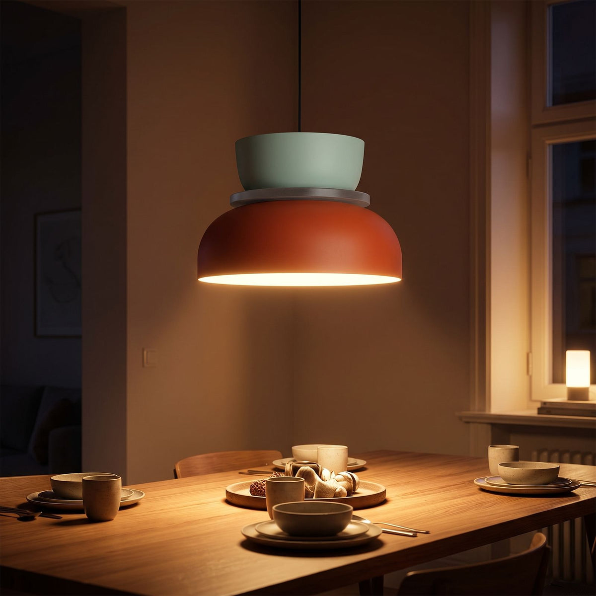 Two-Tone Stacked Metal Bowl Pendant Light above a dining table at night
