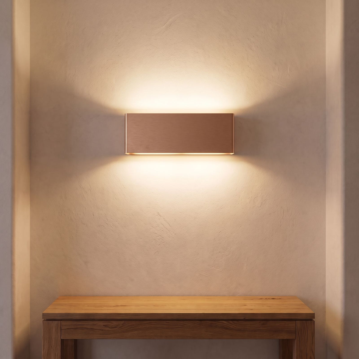Ultra-Thin Brushed Aluminium Up Down LED Wall Light in rose gold above an entry console